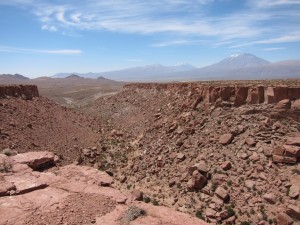 At the margins of the Atacama desert in northeast Chile, wind is thought to carve canyons faster than rivers. This view is looking out of a canyon mouth toward the west, where strong westerly winds have repeatedly attacked this landscape over the past four million years. (Credit: Noah J. Finnegan)