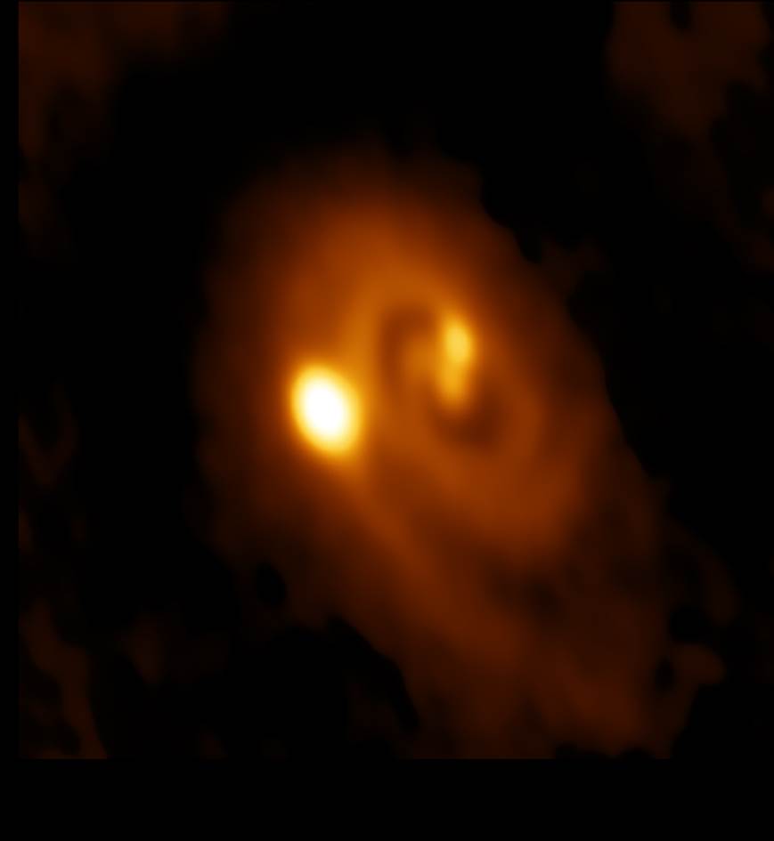 The outermost "arm" of the spiral indicates a recent shift in gravitational stability around the young stars. (Photo credit: B. Saxton: NRAO/AUI/NSF; ALMA (ESO/NAOJ/NRAO)