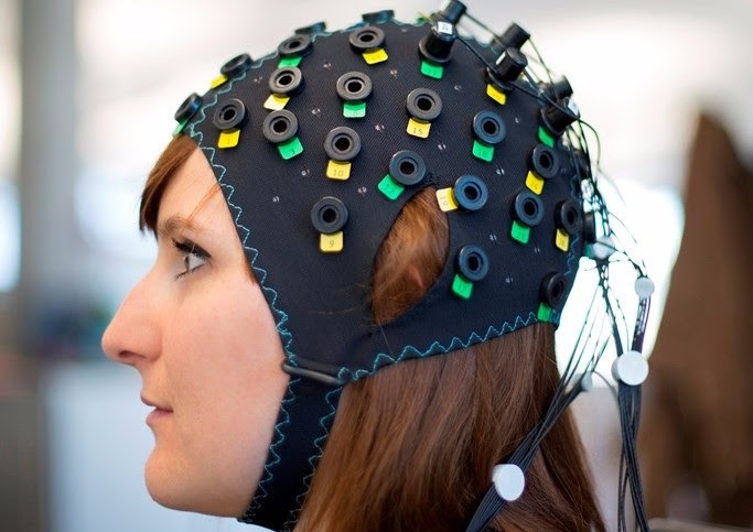 the NIRS/EEG brain computer interface system shown on a model. (Image by Wyss Center)