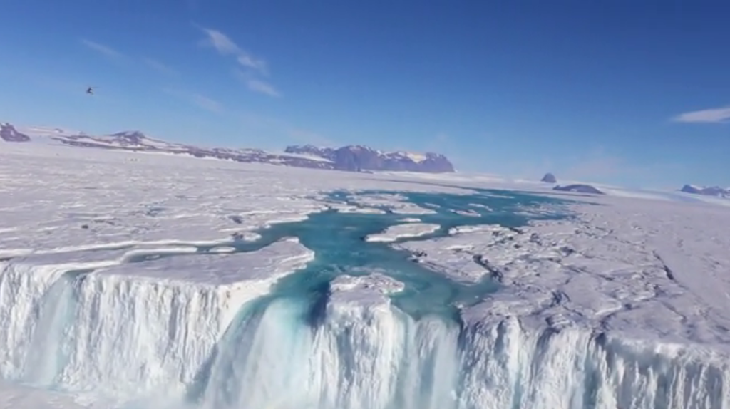 A 400-foot-wide waterfall drains off the Nansen Ice Shelf into the ocean. (Image by Won Sang Lee/Korea Polar Research Institute)