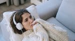 Woman on sofa listening to music. Photo credit: Ivan S, CC0 pexels